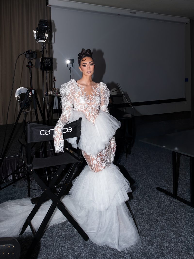 Dubravka Švegar in a white lace gown on a shoot set, beside studio lights