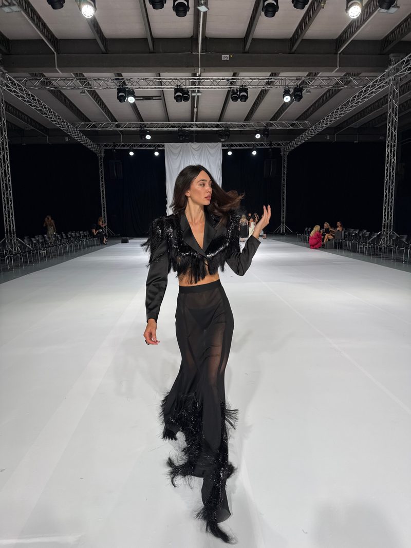Dubravka Švegar on a runway in a black fringed two-piece