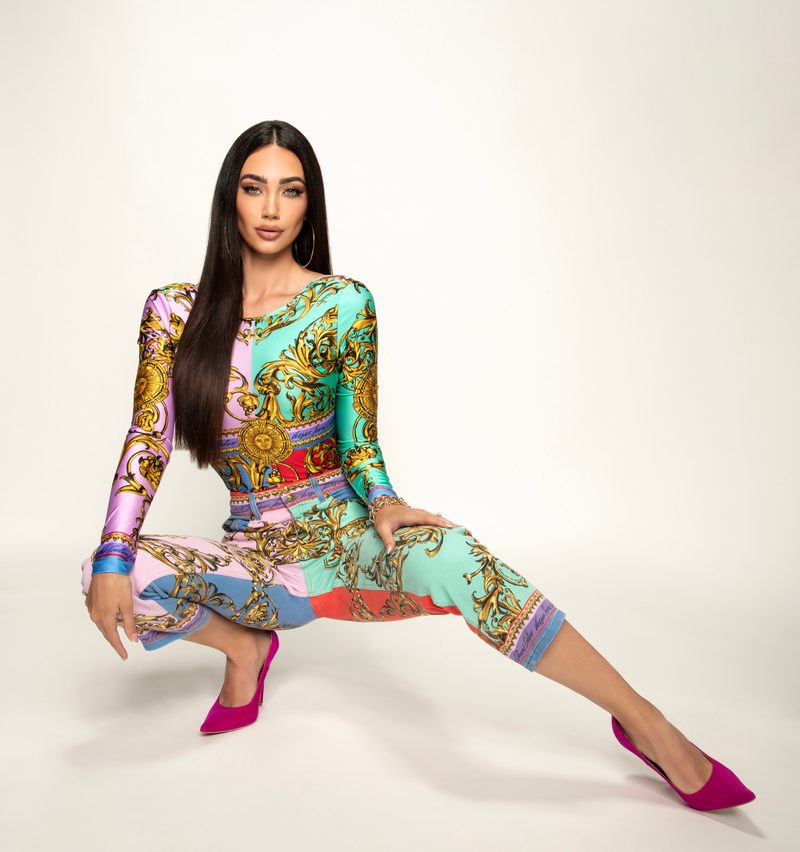 Dubravka Švegar in the studio in a colourful baroque-print bodysuit and pink heels